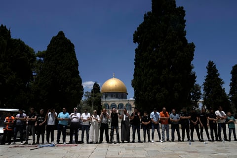 Muslims take part in Friday prayers in the shadow of the Dome of the Rock Mosque in the Al-Aqsa Mosque compound in the Old City of Jerusalem, Friday, Aug. 2